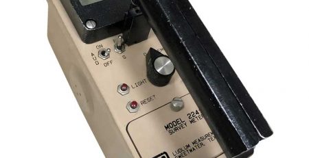 Vintage handheld light meter with analog controls and a solar cell.